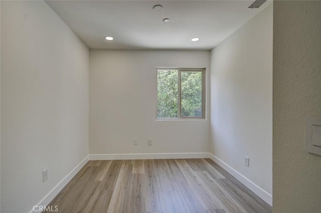 unfurnished room with light wood-type flooring