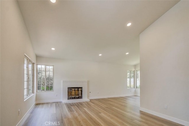 unfurnished living room with a fireplace and light hardwood / wood-style flooring