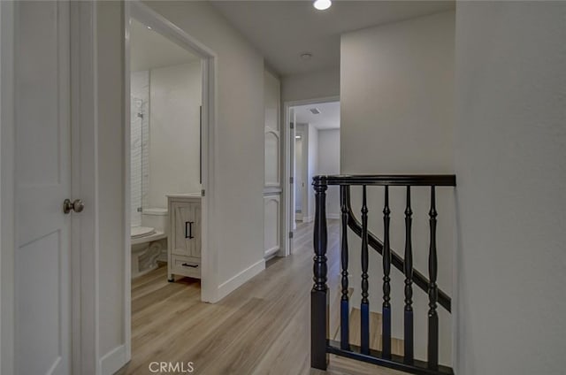 corridor with light wood-type flooring