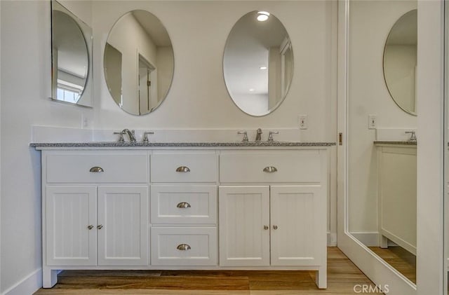 bathroom featuring hardwood / wood-style flooring and vanity