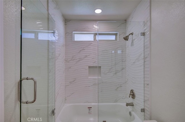 bathroom featuring shower / bath combination with glass door