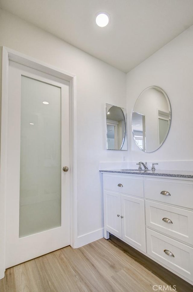 bathroom featuring vanity and hardwood / wood-style flooring