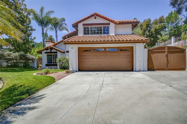 mediterranean / spanish home with a garage and a front yard