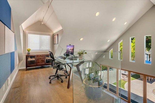 office space with light hardwood / wood-style flooring and high vaulted ceiling