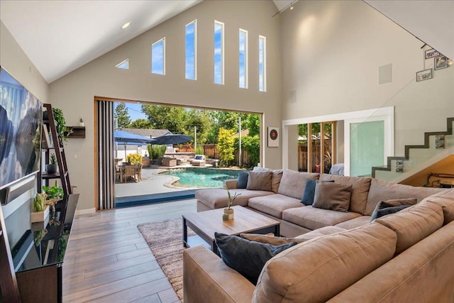 living room with vaulted ceiling and light hardwood / wood-style flooring