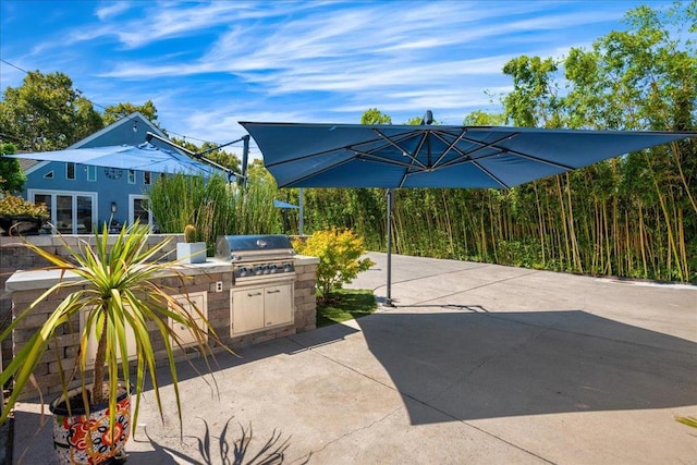 view of patio / terrace featuring an outdoor kitchen and a grill