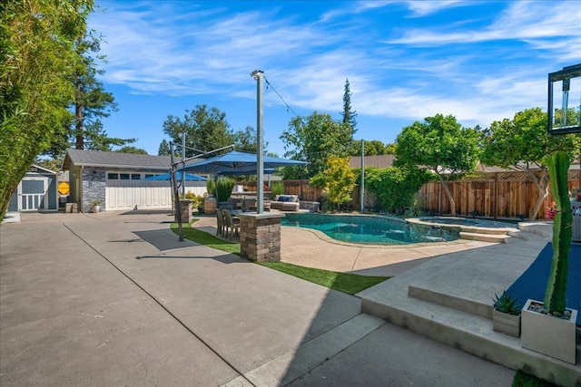 view of pool featuring an in ground hot tub, a patio, and a storage unit