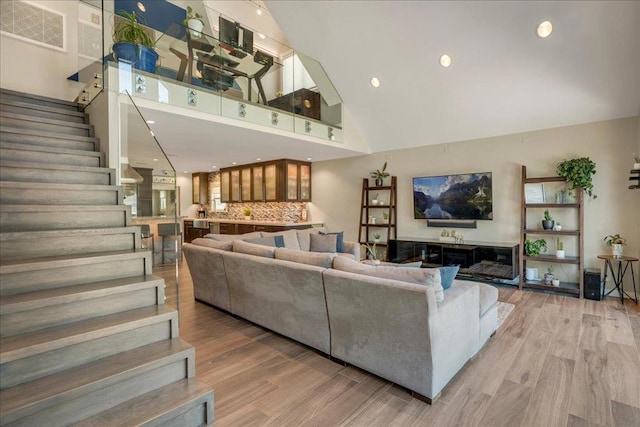 living room featuring wood-type flooring and a high ceiling