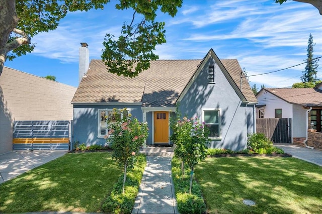 tudor-style house with a front yard