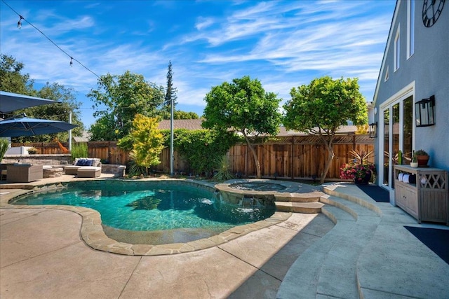 view of pool with an in ground hot tub, an outdoor hangout area, and a patio area