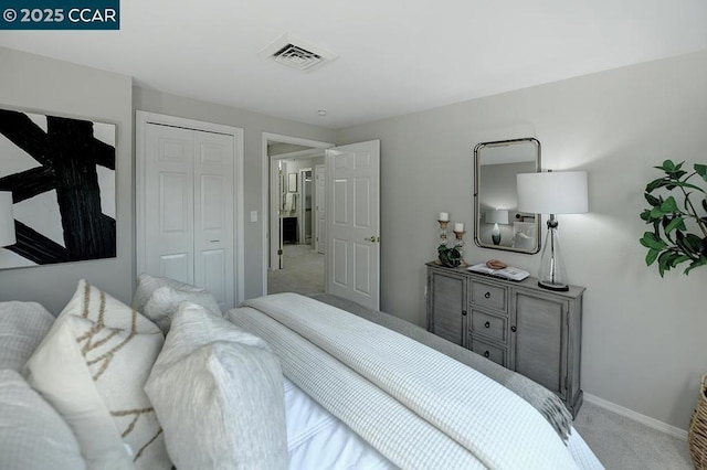 bedroom with light colored carpet and a closet