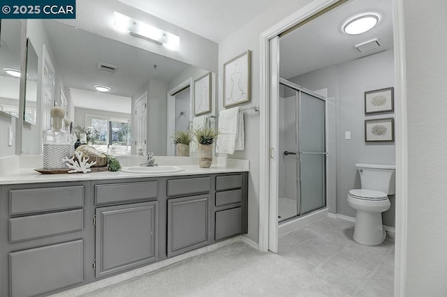 bathroom featuring an enclosed shower, vanity, and toilet