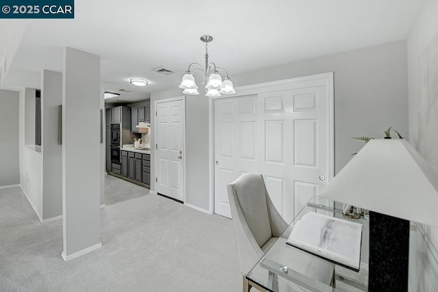 office area featuring light colored carpet and a chandelier