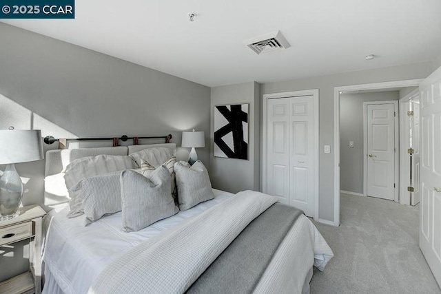 bedroom featuring light carpet and a closet