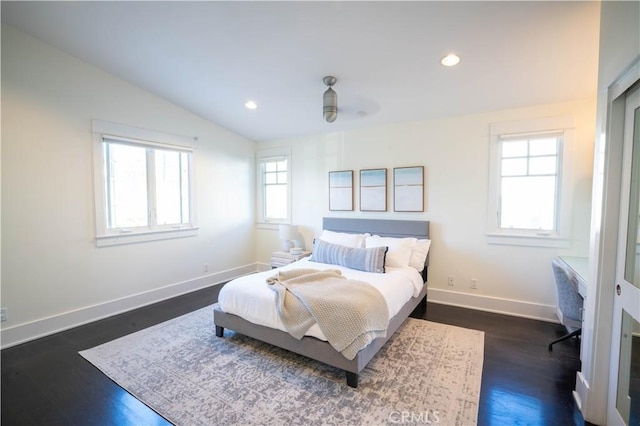 bedroom featuring dark wood-type flooring and vaulted ceiling