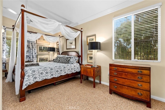 carpeted bedroom featuring crown molding