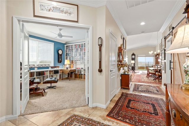 carpeted entrance foyer with crown molding, lofted ceiling, and a notable chandelier