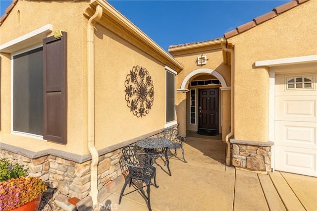 doorway to property with a garage