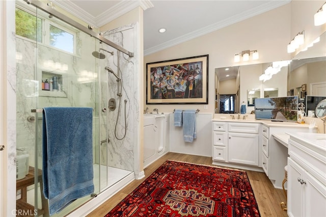 bathroom featuring crown molding, wood-type flooring, an enclosed shower, and vanity