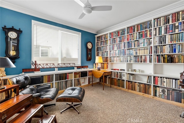 living area with ornamental molding, carpet floors, and ceiling fan