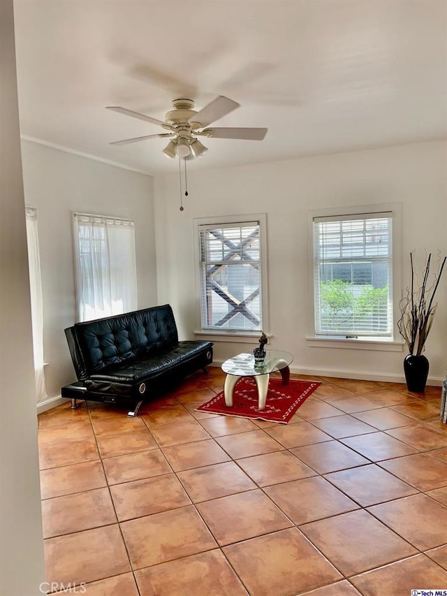 living room featuring a ceiling fan, tile patterned flooring, and baseboards