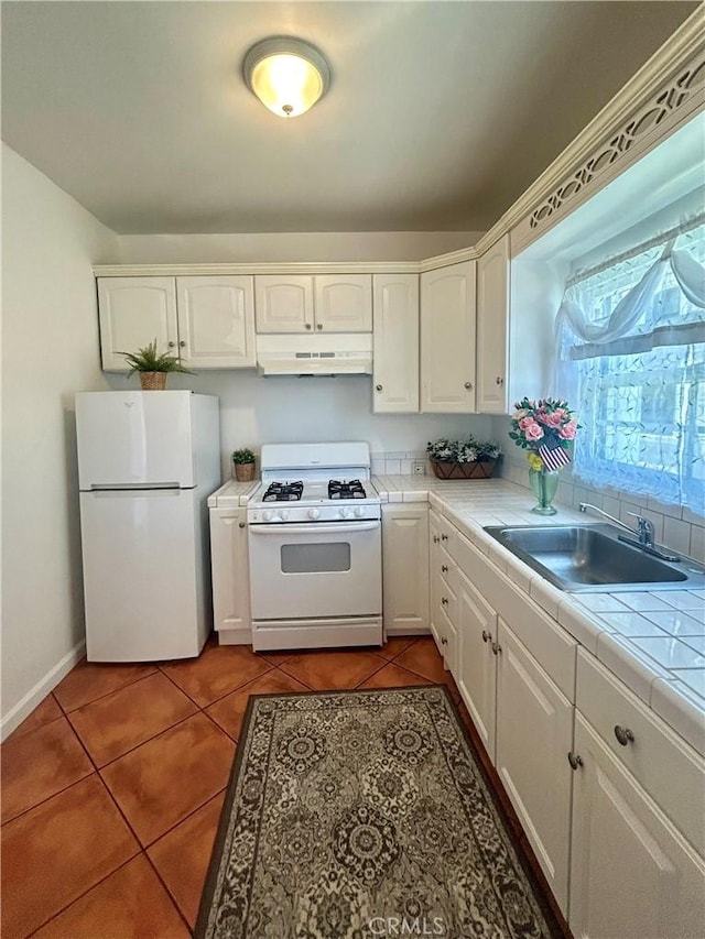 2121 James M Wood Blvd Unit 224, Los Angeles, CA 90006 - kitchen featuring white appliances, under cabinet range hood, tile countertops, and white cabinets