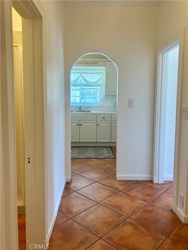 2121 James M Wood Blvd Unit 224, Los Angeles, CA 90006 - corridor with arched walkways and light tile patterned floors