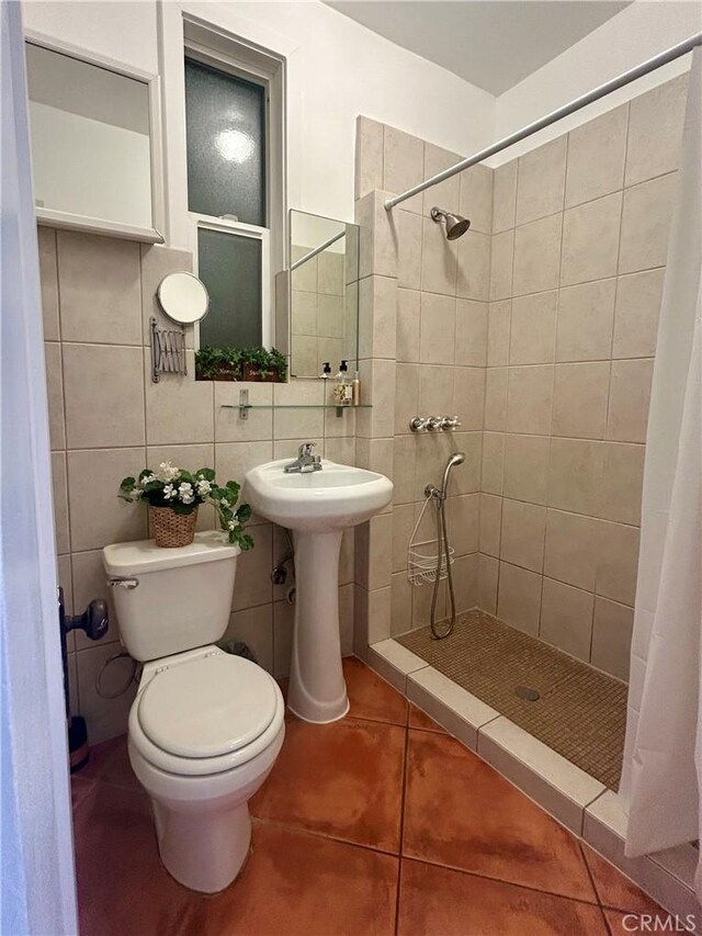 2121 James M Wood Blvd Unit 224, Los Angeles, CA 90006 - full bathroom with a stall shower, tile walls, tile patterned floors, and decorative backsplash