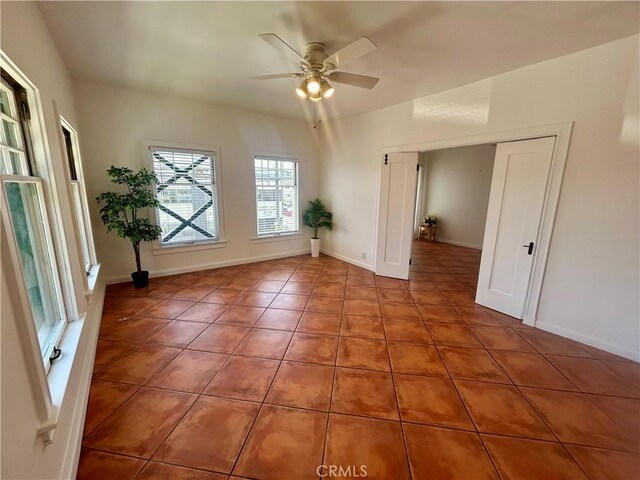 2121 James M Wood Blvd Unit 224, Los Angeles, CA 90006 - tiled empty room featuring a ceiling fan and baseboards