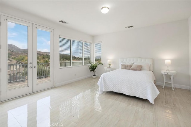 bedroom featuring a mountain view, access to outside, and french doors