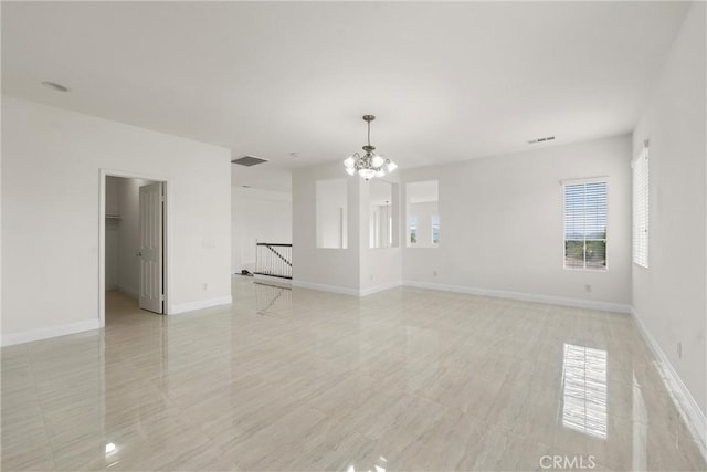 empty room featuring a notable chandelier