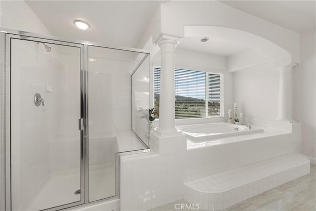 bathroom with decorative columns and separate shower and tub