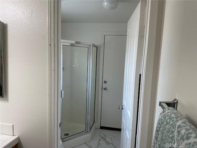 bathroom featuring vanity and a shower with shower door