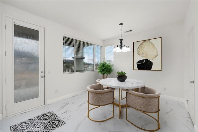 dining space featuring a chandelier and breakfast area