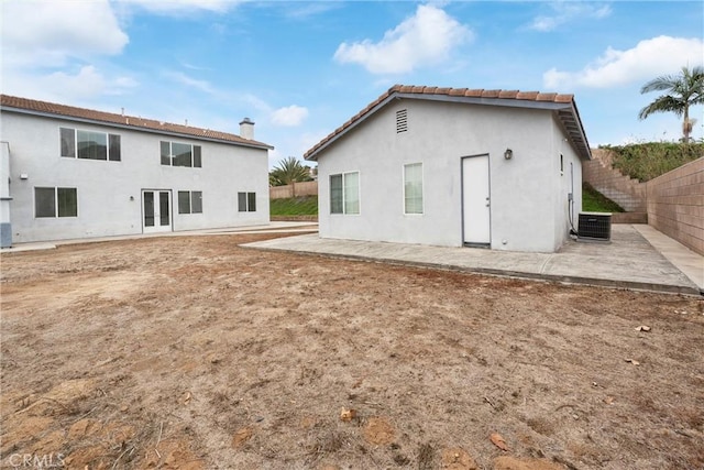 back of property with a patio area and central air condition unit