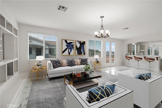 living room featuring a notable chandelier and a wealth of natural light