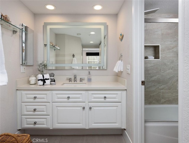 bathroom featuring vanity and tiled shower / bath combo