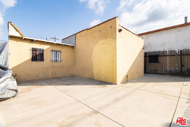 view of side of home featuring a patio