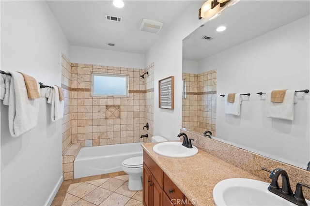 full bathroom with tile patterned floors, vanity, toilet, and tiled shower / bath combo