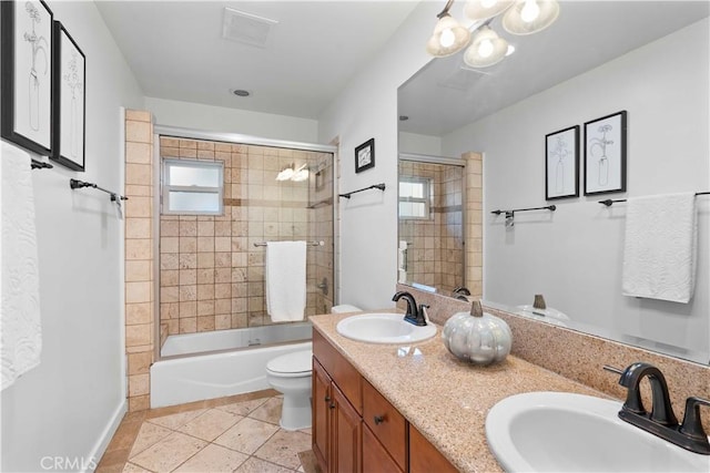 full bathroom featuring toilet, vanity, bath / shower combo with glass door, and tile patterned flooring