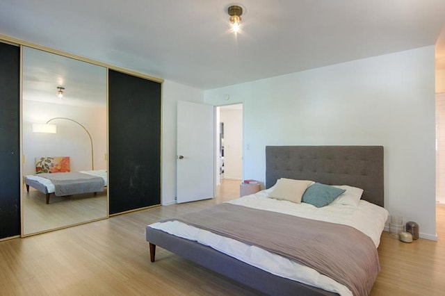 bedroom featuring a closet and light hardwood / wood-style flooring