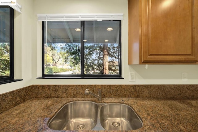 room details featuring sink and dark stone counters