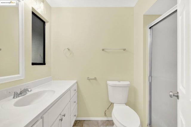 bathroom with vanity, toilet, and a shower with shower door