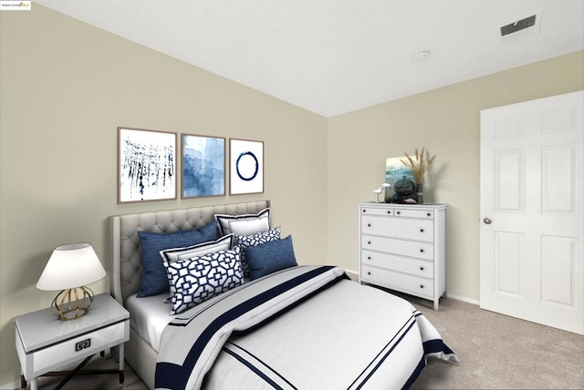 bedroom featuring vaulted ceiling and light colored carpet