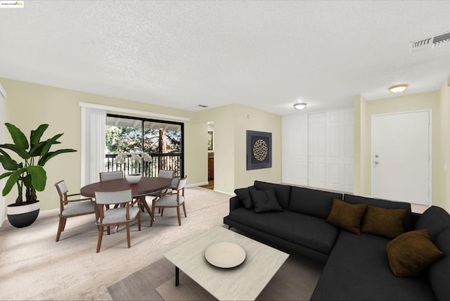 carpeted living room featuring a textured ceiling