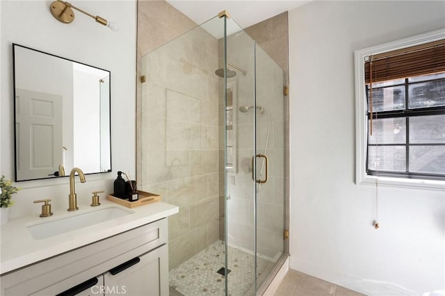 bathroom featuring vanity, tile patterned flooring, and a shower with shower door