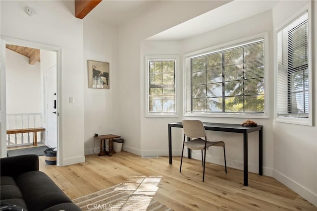 office area featuring beam ceiling and light hardwood / wood-style flooring