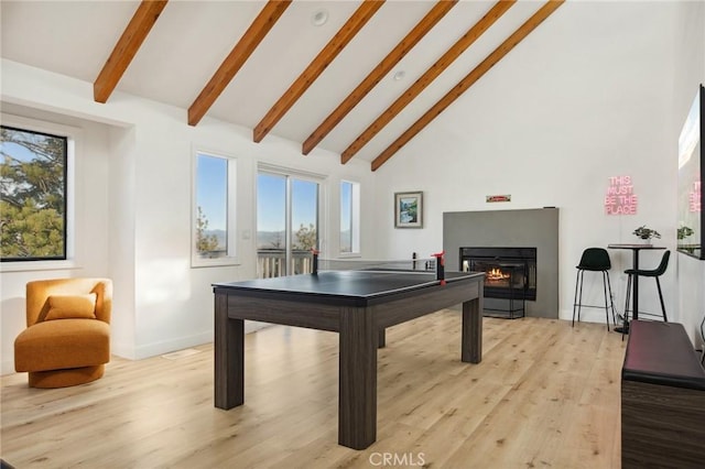 rec room with high vaulted ceiling, light hardwood / wood-style floors, and beamed ceiling