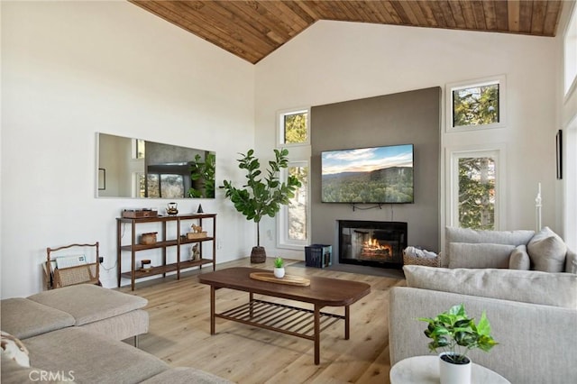 living room with plenty of natural light, high vaulted ceiling, and wooden ceiling