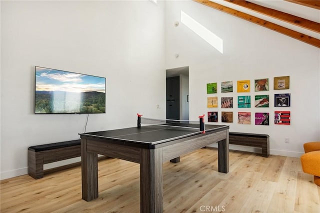 rec room featuring beam ceiling, light hardwood / wood-style flooring, and high vaulted ceiling